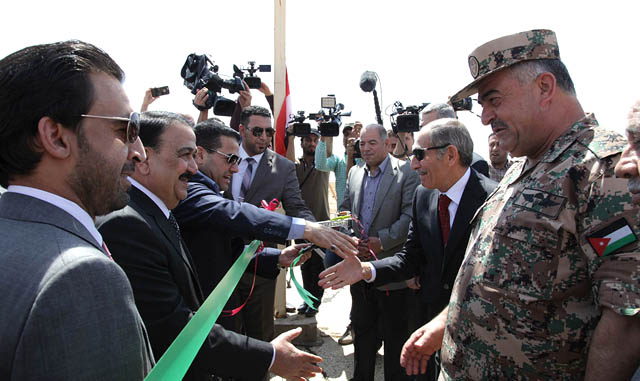 Jordanian and Iraqi officials greet each other as they reopen the Turaibil border crossing after two years of closure on Wednesday (Petra photo)